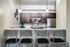 Chic modern kitchen with elegant bar seating, pendant lighting, stainless steel appliances, and stylish decor accents.