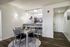 Chic open-plan dining and kitchen area featuring sleek modern furniture, elegant lighting, and a welcoming atmosphere perfect for entertaining.
