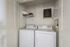 Chic and functional laundry nook with washer and dryer, complemented by elegant shelving and modern decor.