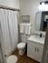 Chic bathroom with elegant marble countertop, sleek vanity, and gleaming fixtures, offering a serene retreat.