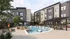 Modern apartment complex with a luxurious pool area, stylish loungers, and lush greenery, perfect for relaxation and social gatherings.