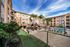 Vibrant apartment community with lush landscaping, spacious courtyard, sparkling swimming pool, and recreational volleyball court.