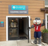 Inviting entrance of Avery Leasing Center with a welcoming mascot, showcasing community spirit and hospitality.