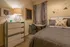 Cozy bedroom with modern decor featuring a stylish geometric lamp, chic dresser, and a comfortable study nook.