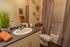 Elegant bathroom with modern fixtures, stylish decor, and plush towels, featuring a soothing color palette.