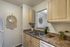 Inviting kitchen with elegant wood cabinetry, double sink, and cozy decor accents, perfect for culinary creativity.