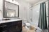 Elegant bathroom with modern fixtures, granite countertop, and a cozy ambiance enhanced by soft lighting.
