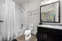 Inviting bathroom with modern design, featuring elegant white tiles, a granite countertop, and motivational decor.