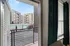 Inviting apartment view showcasing modern outdoor pool area and stylish residential architecture through the window.