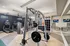 Modern fitness center equipped with state-of-the-art machines, sleek weight racks, and ample space for a dynamic workout experience.