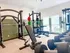 Bright and modern fitness center equipped with state-of-the-art gym equipment and large windows for natural light.