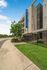Modern apartment building with lush landscaping and clear blue skies, highlighted by prominent Altitude signage.
