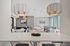 Modern apartment lounge featuring stylish pendant lighting, chic seating, and a sleek pool table, perfect for relaxation and entertainment.