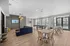Modern communal lounge area with stylish furniture, cozy seating, and large windows offering natural light, perfect for social gatherings.