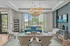 Elegant lounge with stylish modern chairs, vibrant blue sofa, and decorative accents, inviting natural light through large windows.
