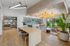 Inviting open-concept living space featuring elegant bar seating, modern lighting, and a large window with scenic views.