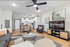 Modern open-concept living space with a cozy seating area, stylish kitchen, and chic decor at Statehouse Arena.