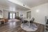 Modern open-plan living and dining area with sleek flooring, stylish furniture, and ample natural light.