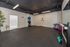 Modern yoga studio with sleek flooring, vibrant fitness balls, and mirrored wall for an inspiring workout atmosphere.
