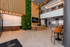 Modern lobby with a vibrant green wall, stylish seating, and sleek reception area at 865 East Residences.