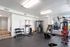 Bright and modern home gym featuring top-notch exercise equipment with ample natural light and stylish decor.