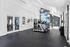 Sleek and modern fitness center featuring high-quality treadmills, expansive windows, and motivational wall art for an energizing workout.
