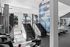 Modern fitness center with state-of-the-art stair climbers, inspiring motivational wall, and floor-to-ceiling windows providing natural light.