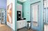 Modern corner coffee station with sleek cabinetry, teal accents, and a contemporary coffee machine.