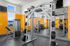 Bright and modern fitness center with state-of-the-art equipment and vibrant orange accents.