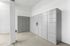 Modern package room with sleek, grey lockers and clean white walls.