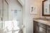 bathroom with one sink, shower, and toilet