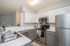 kitchen with stainless steel appliances and grey and white cabinets