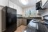 kitchen with black appliances and grey and white cabinets