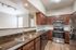 Arrive on University Kitchen with Wooden Cabinets and Stainless Steel Appliances