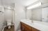 Arrive North Bethesda Bathroom with White Countertops and Brown Cabinets