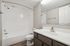 Arrive North Bethesda Bathroom with White Countertops and Brown Cabinets