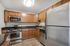 Arrive North Bethesda Kitchen with Brown Cabinetry and Stainless Steel Appliances
