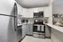 kitchen with stainless steel appliances and grey and white cabinets