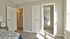 Furnished bedroom with walk-in closet