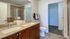 Bathroom with two sinks, toilet, and shower and closet