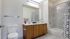 Bathroom with two sinks, toilet, and shower