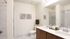 Bathroom with two sinks, toilet, and shower