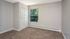 Vacant bedroom with large closet and window