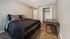 Bedroom with bed, large closet, and desk