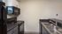 Kitchen with black appliances and white/grey cabinets