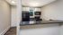 Kitchen with breakfast bar and black appliances