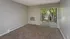 Carpeted living room with sliding door to patio