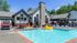 Pool area with lounge chairs and tables with umbrellas