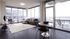 Furnished living room and dining room with wall to wall windows