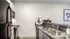 Kitchen with black appliances and white/grey cabinets